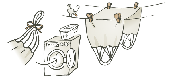 Eine Illustration vom Hängesessel wie er nach dem Waschen auf einer Wäscheleine aufgehangen wird.